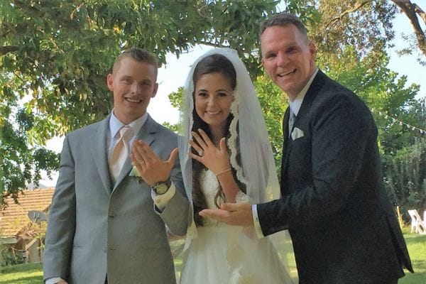 Ryan and Kymberli showing off their rings after being married in San Marcos